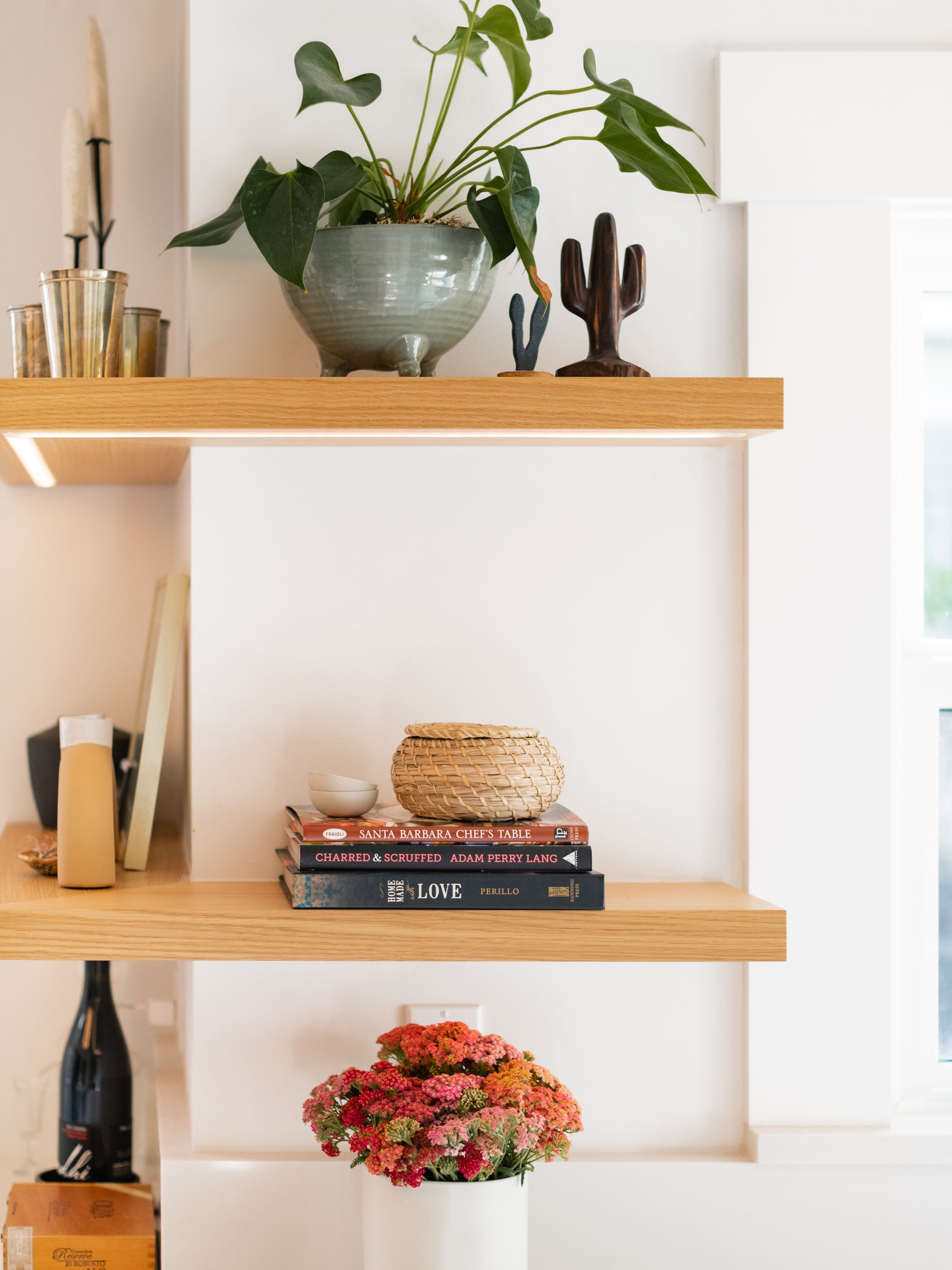 Outside corner floating shelves with led strip mounted on wall with accessories on top