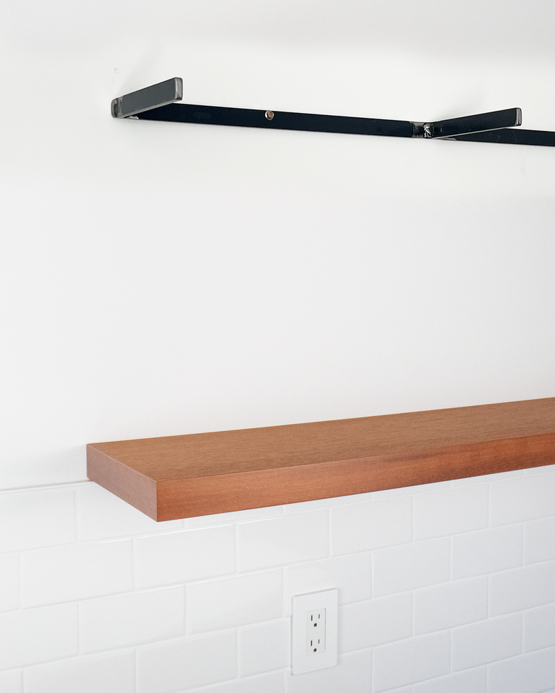 metal bracket for floating shelf above floating shelf in african mahogany