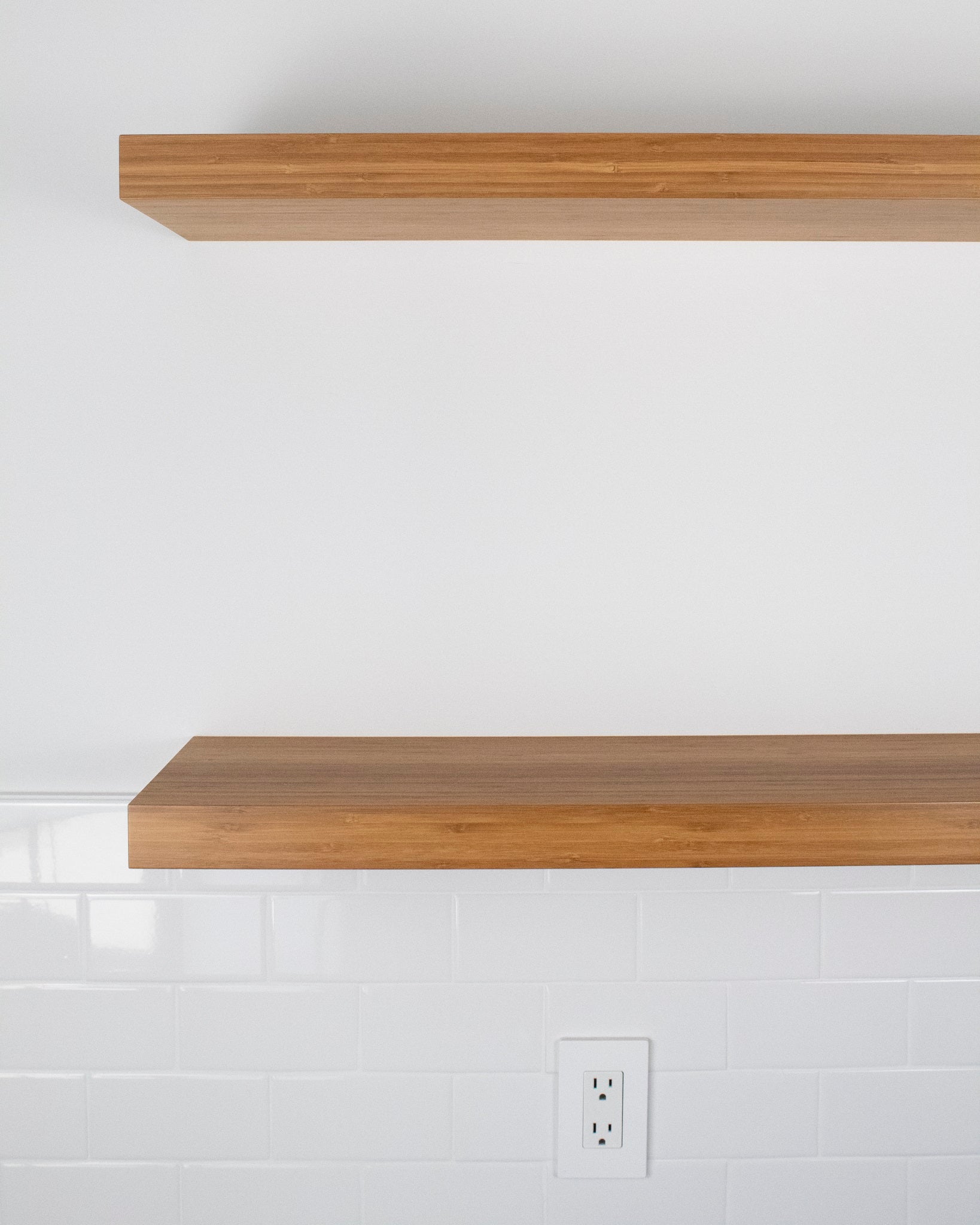 two bamboo floating shelves mounted on a wall front view