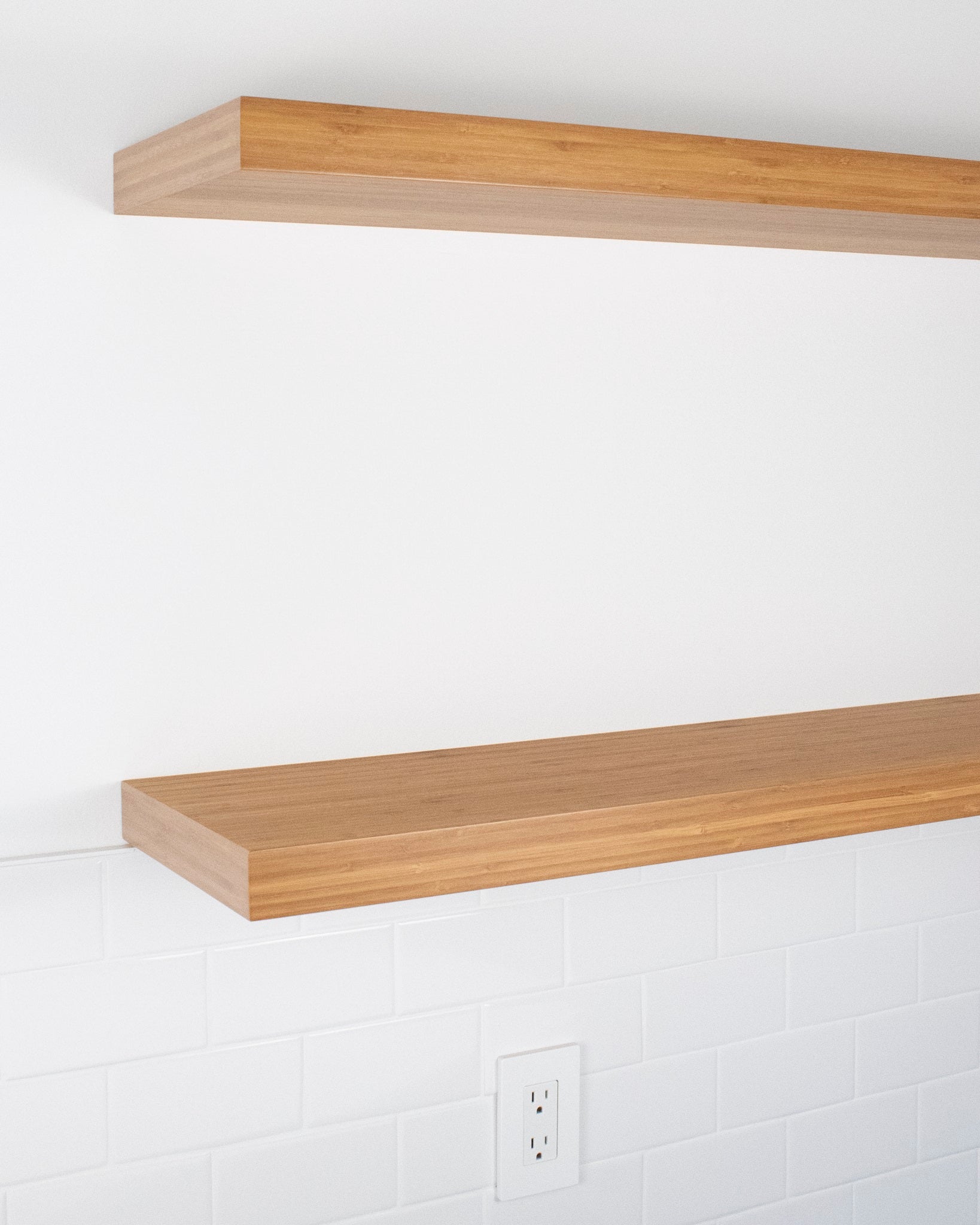 two bamboo floating shelves at side angle view one mounted above another