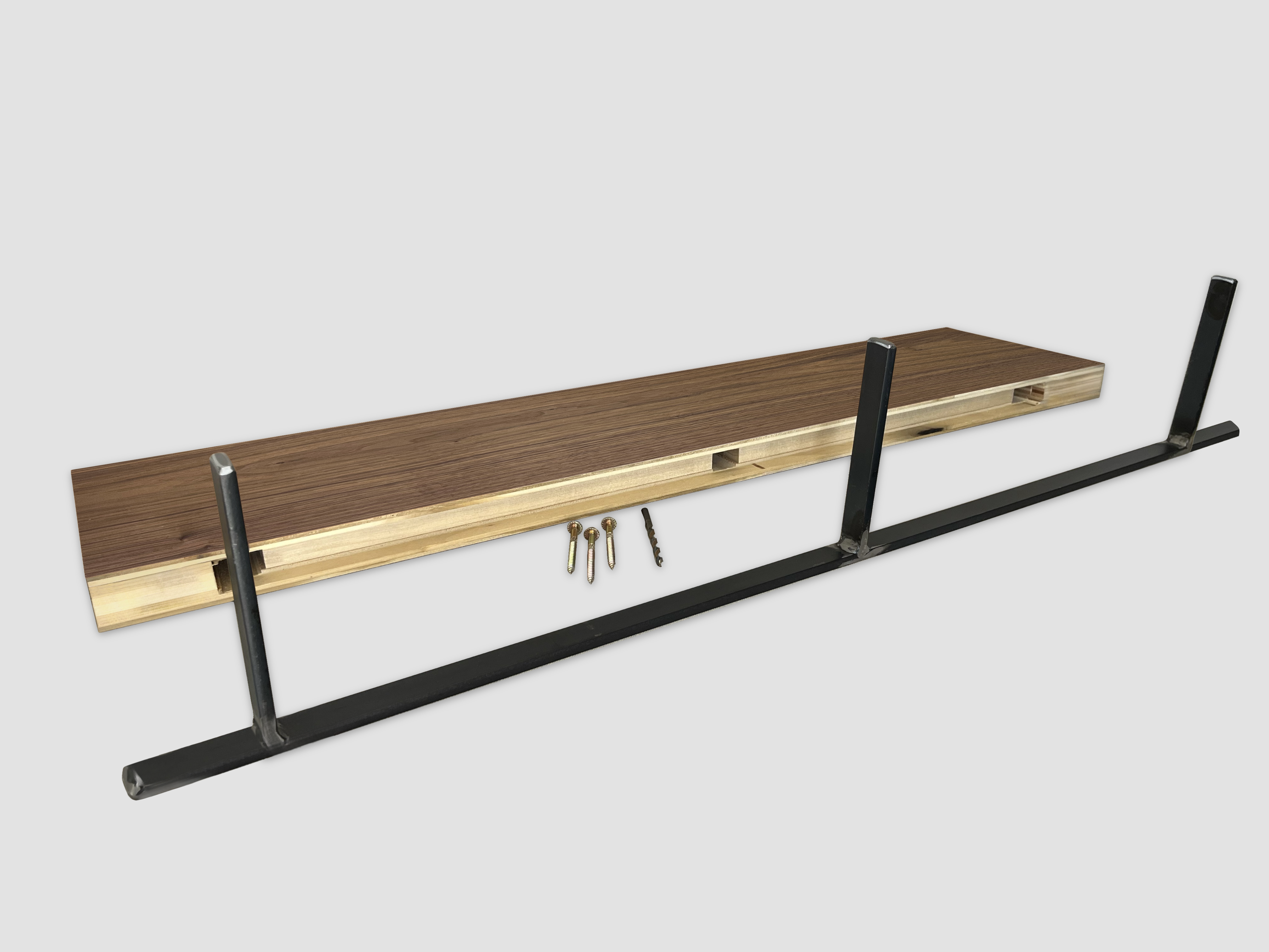 Walnut floating shelf back edge with black metal bracket on a white background