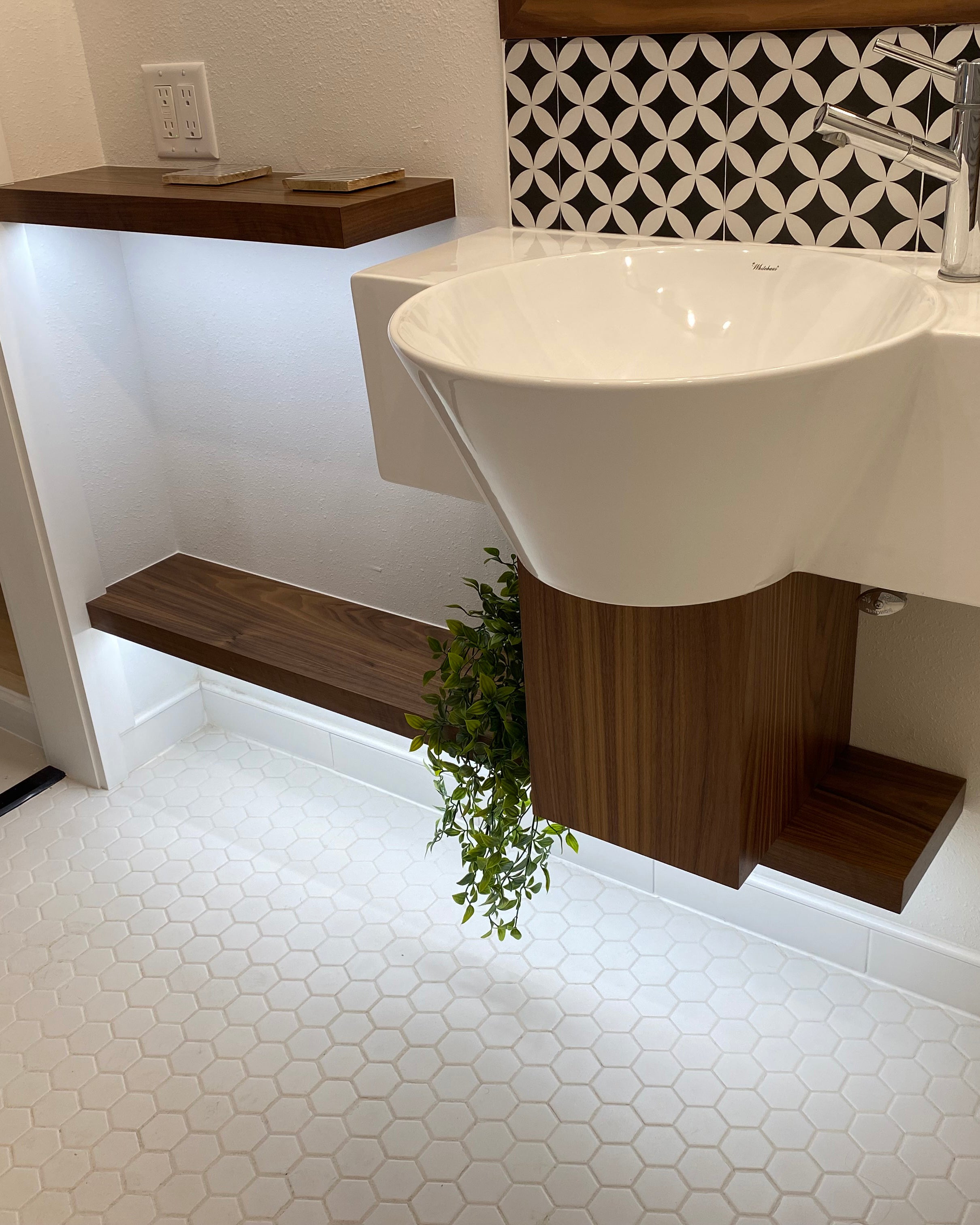Teack floating shelves in a bathroom install with undermounted LED lights