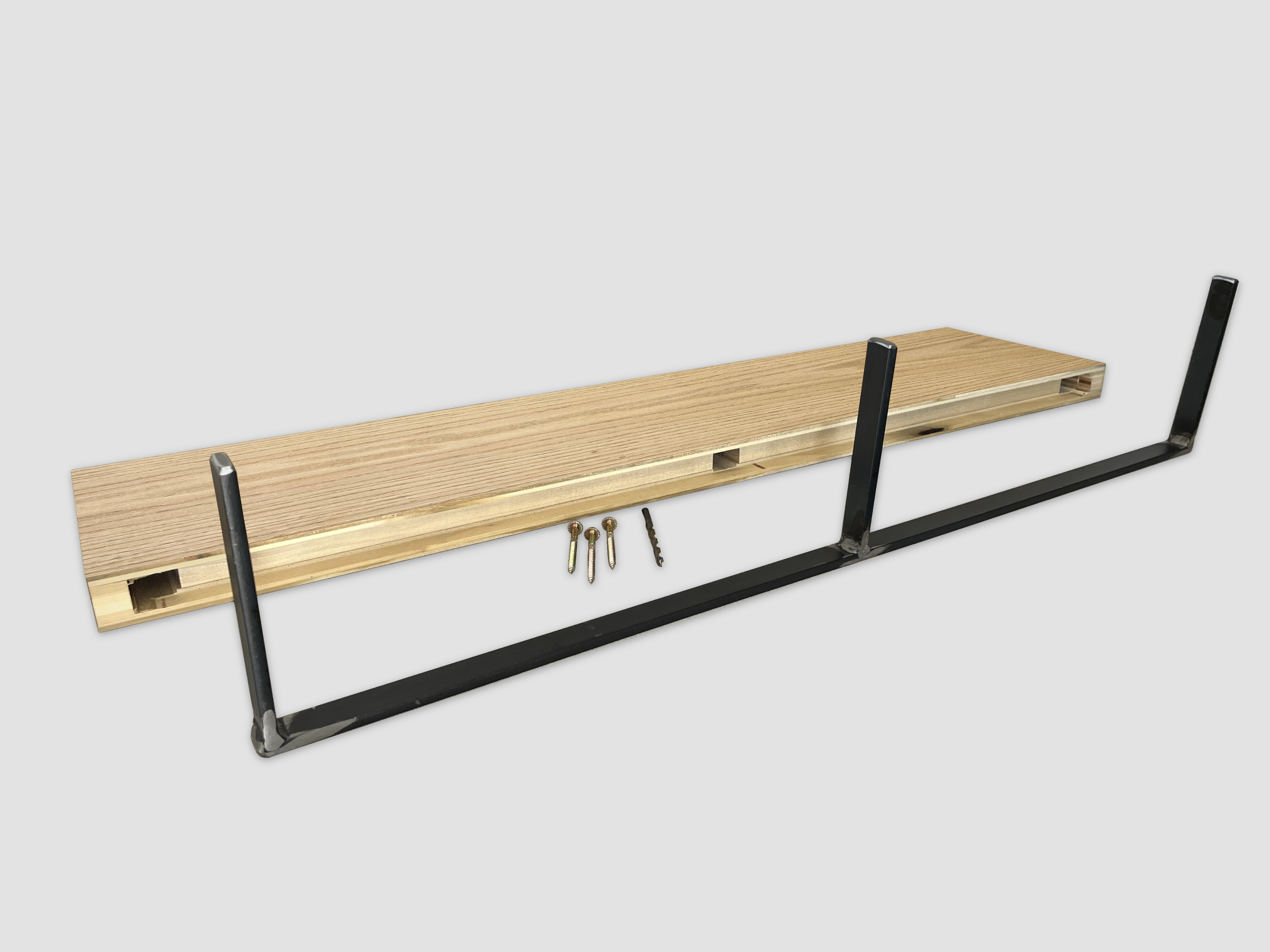 back view of a light oak wood floating shelf with a metal mounting bracket and hardware