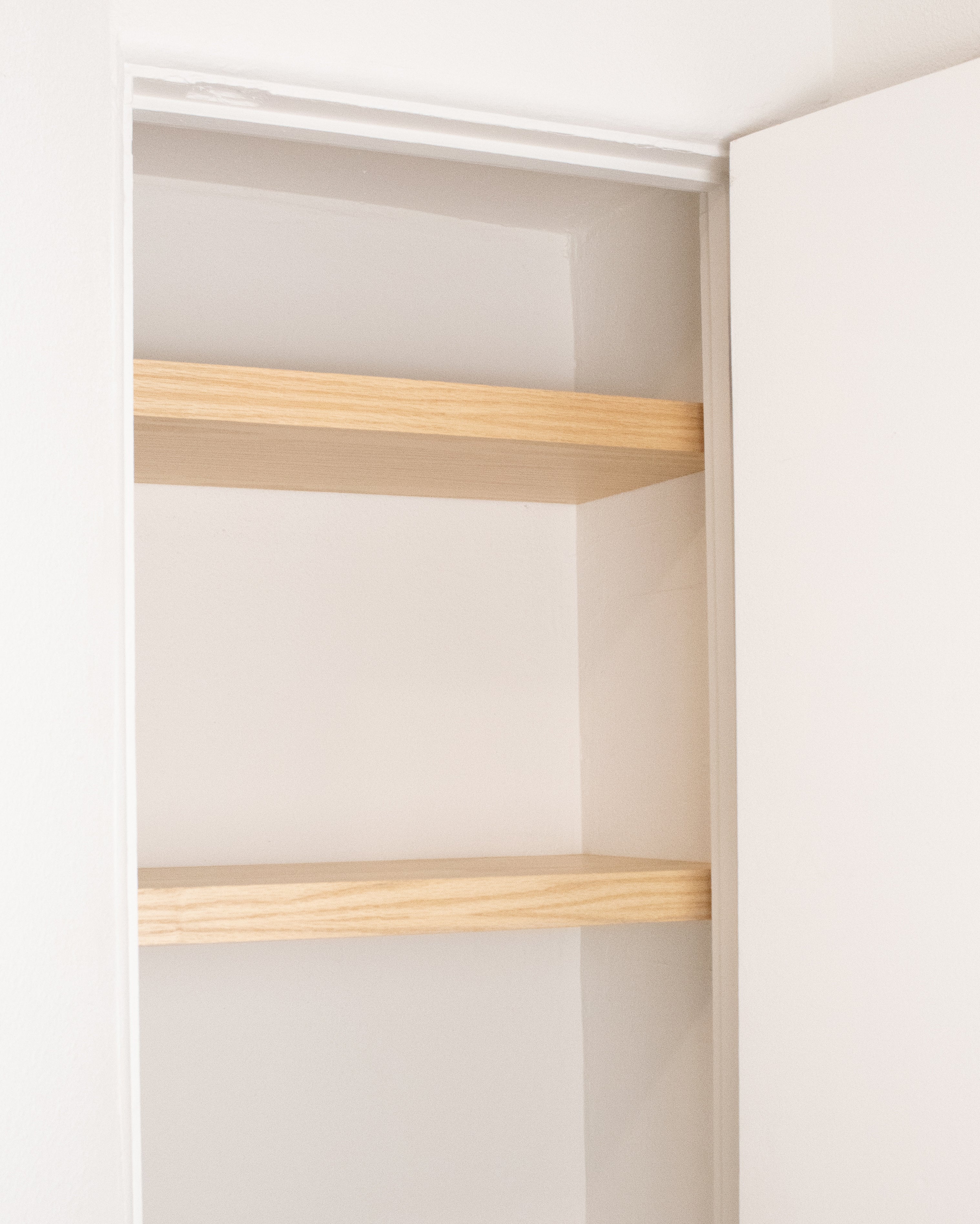 closet floating shelf split-assembly behind closet wing walls