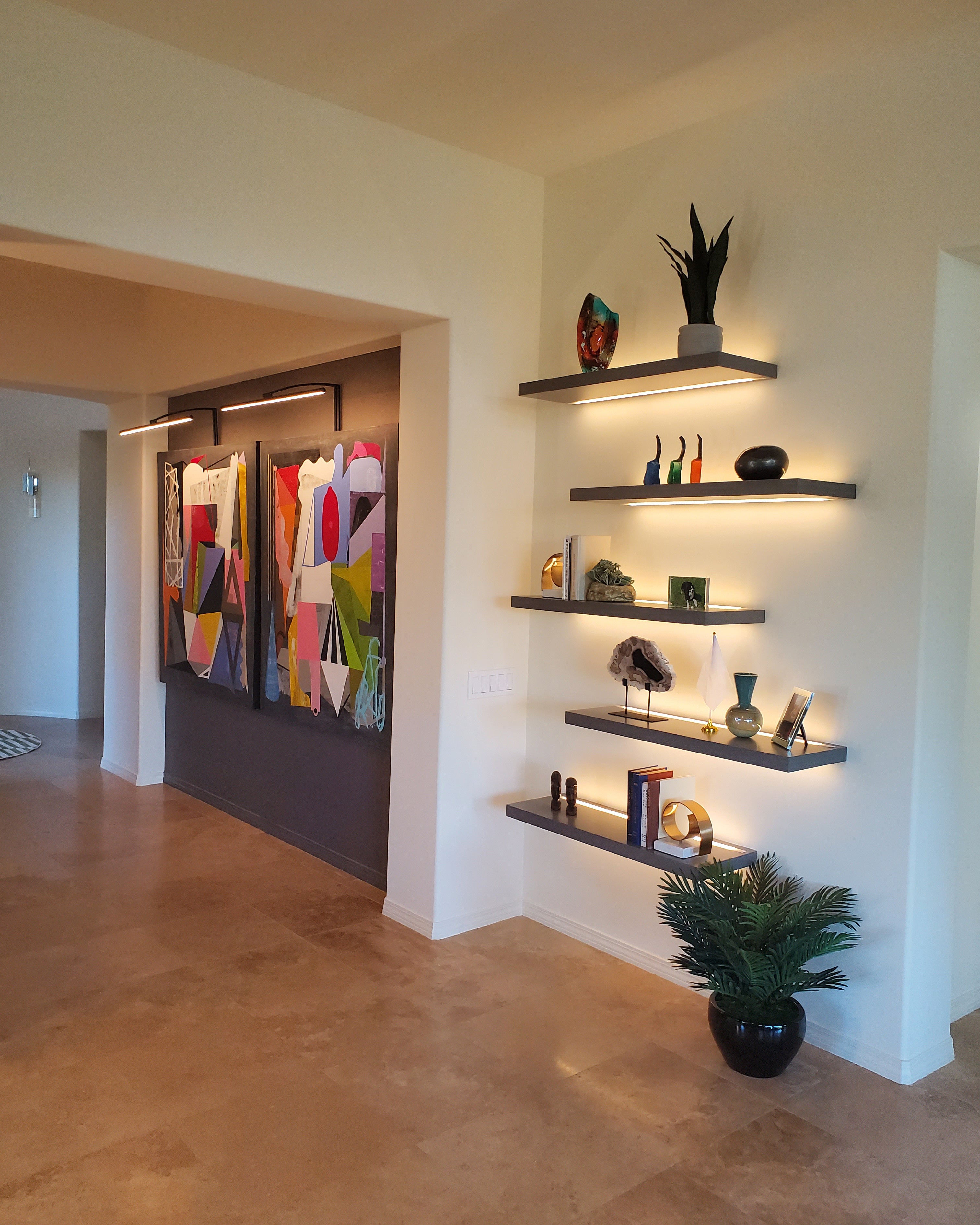 Floating shelves with lighting channels mounted on a wall