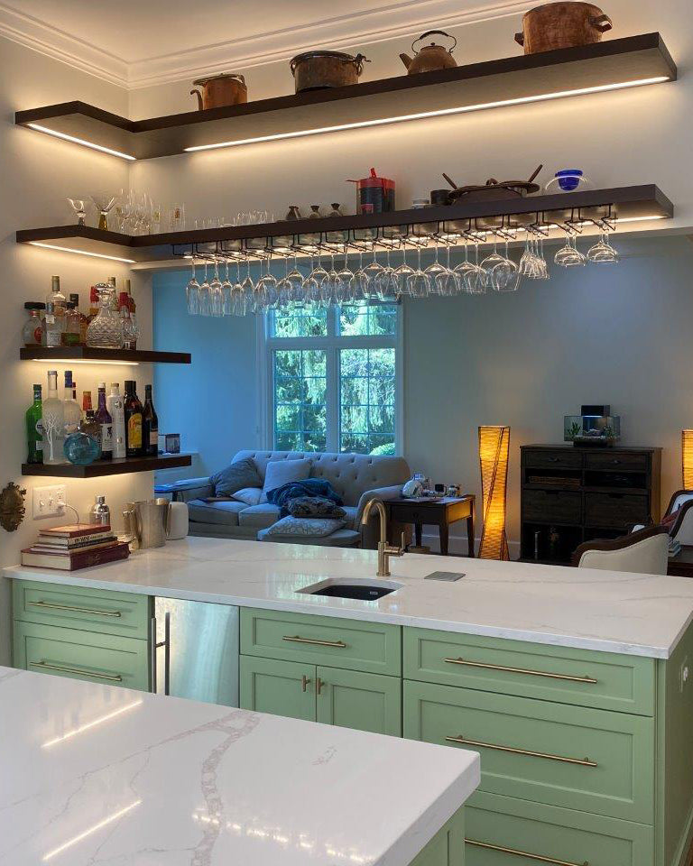 Inside corner floating shelves in a kitchen with custom LED lighting channels on underside