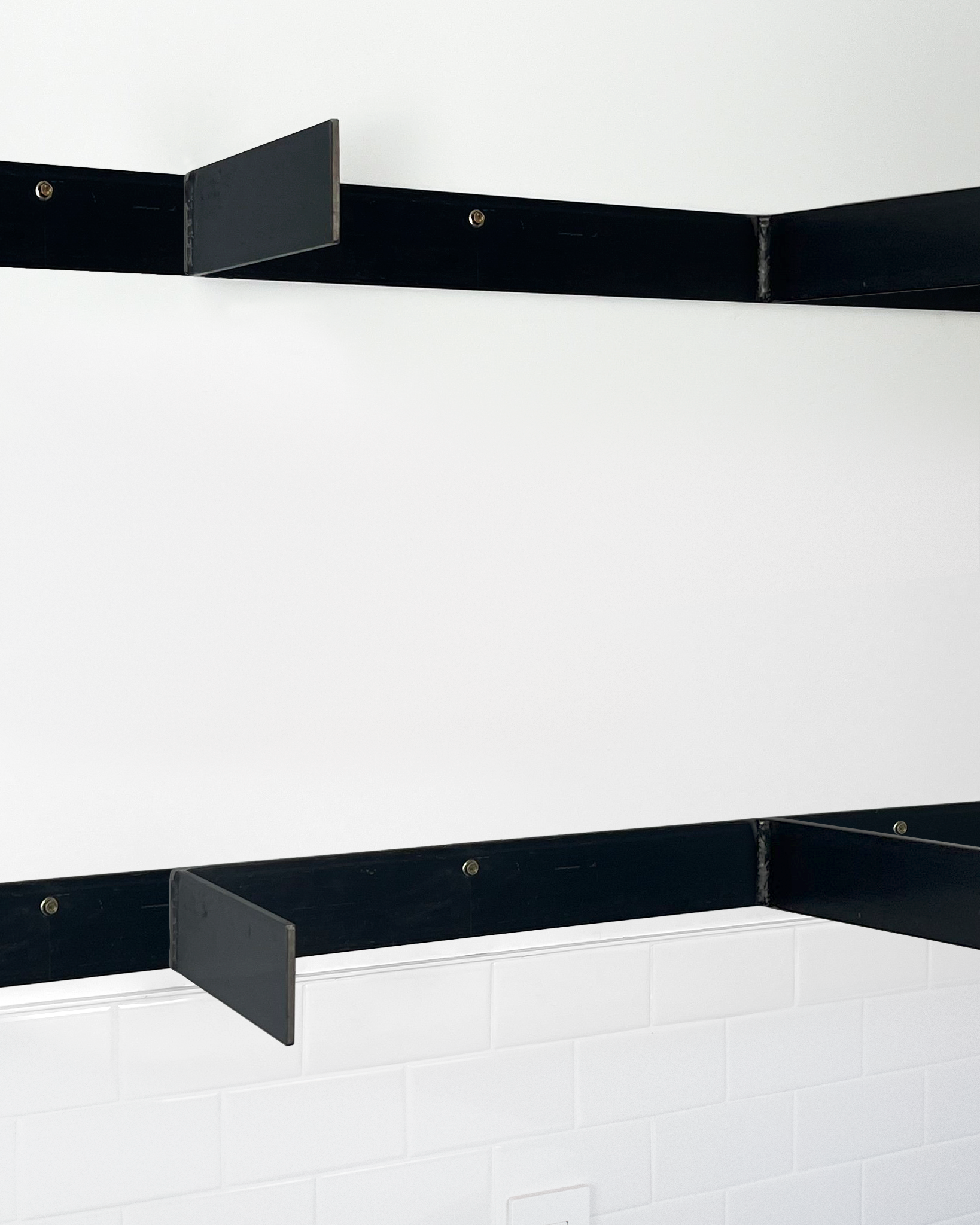 steel 4 inch floating shelf brackets installed without shelves angle view
