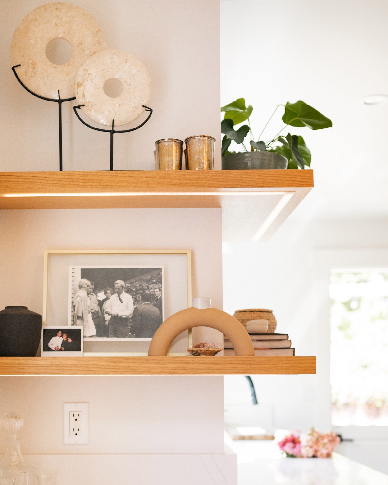 Outside corner floating shelves with LED channels installed displaying accessories