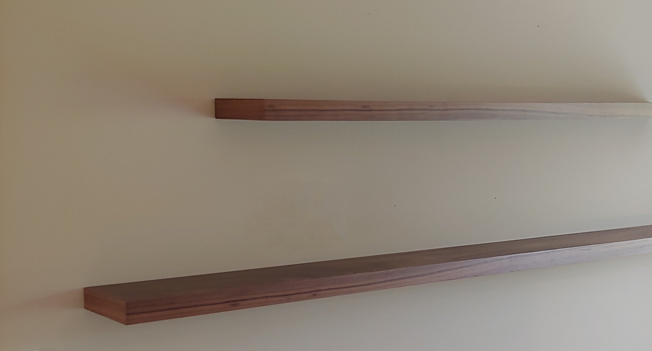 Two six inch floating shelves mounted on a wall