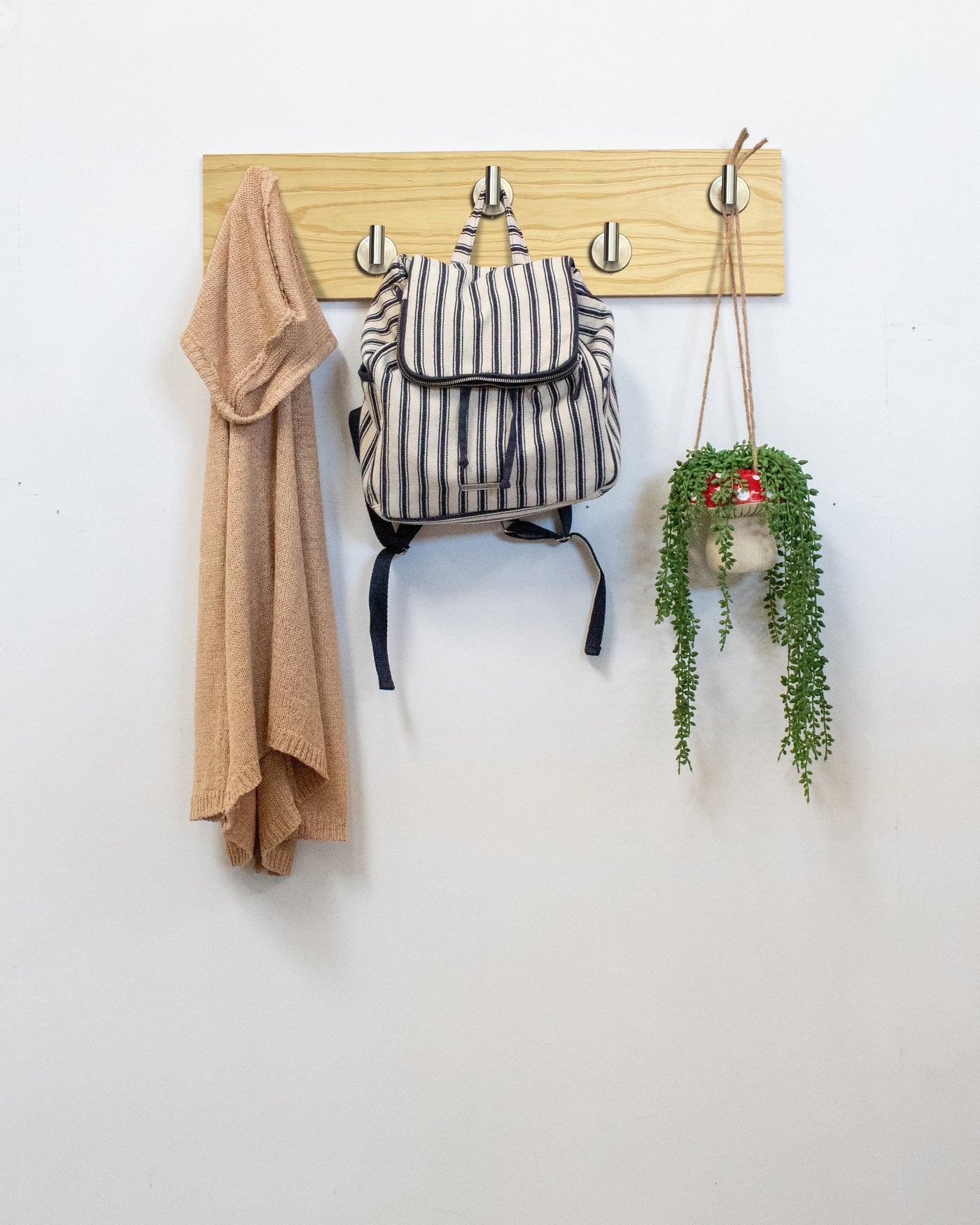 Ash Wood wall hook rack satin nickel hooks with a backpack, coat, and plant