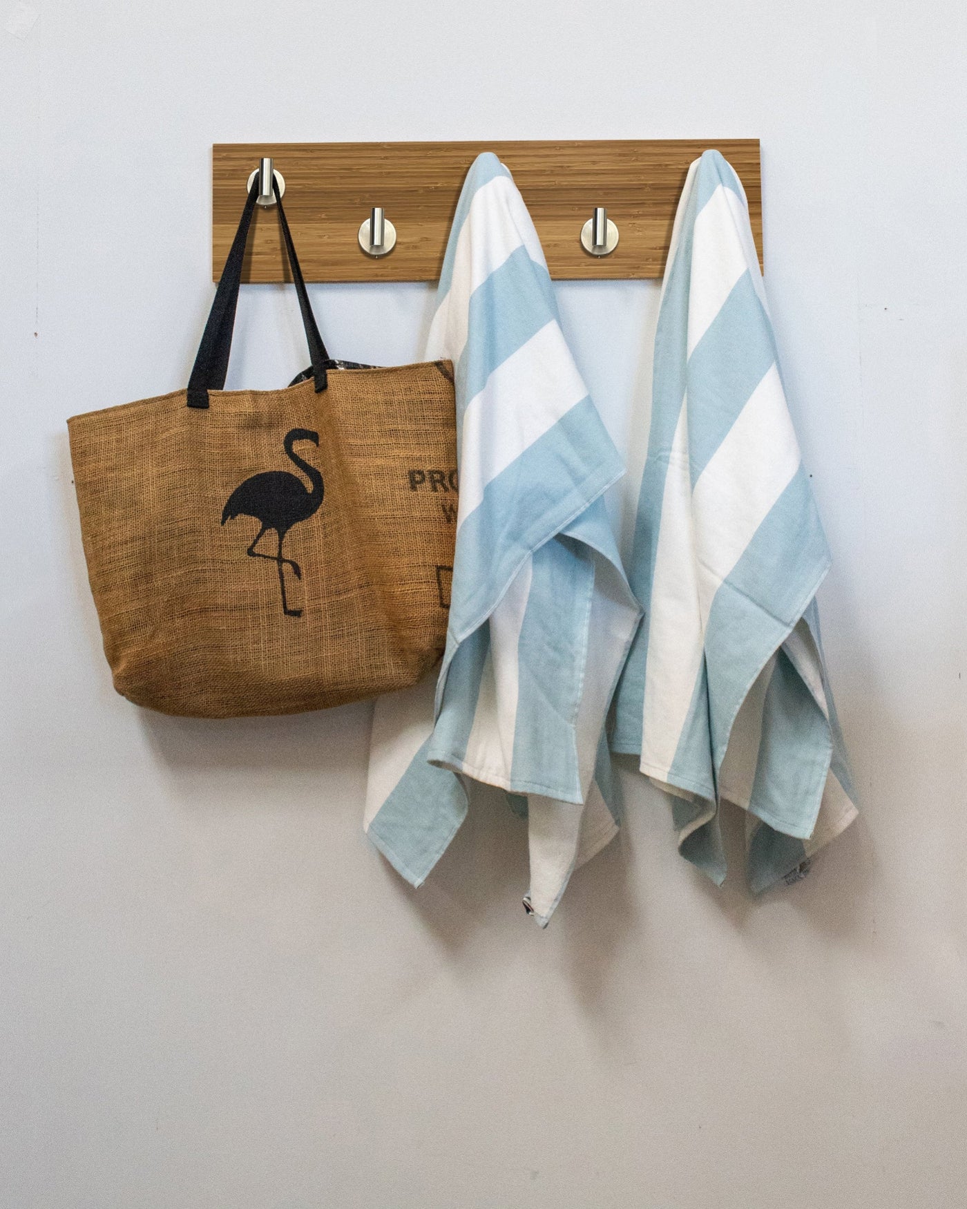 Bamboo wood wall hook rack brown tote bag with flamingo design and two striped towels hanging on 5 satin nickel hooks 