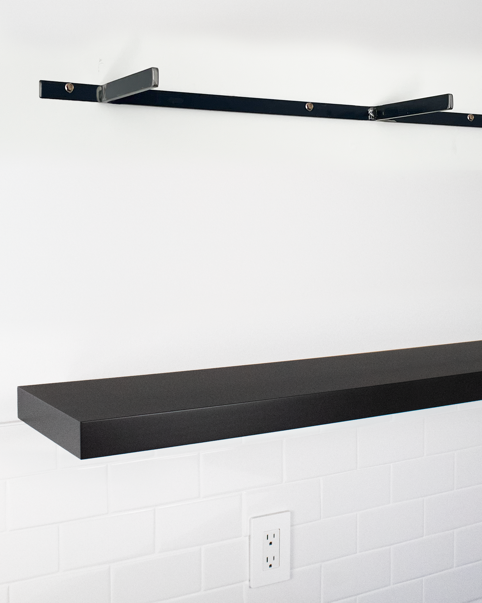 Black floating shelf 1.75 inch thick angle view installed steel HW top