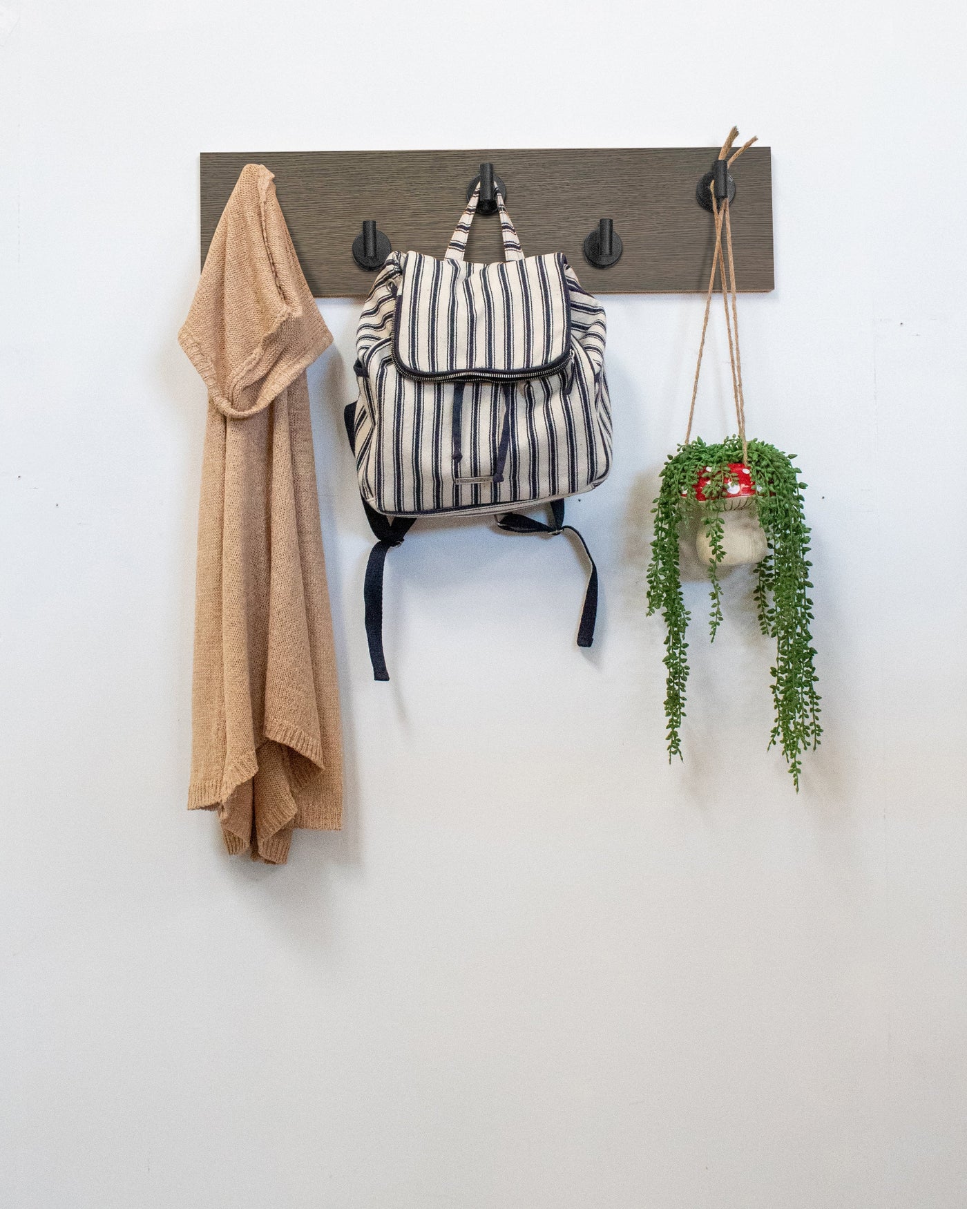 Driftwood Grey Oak wall hook rack matte black hooks with a backpack, coat, and plant