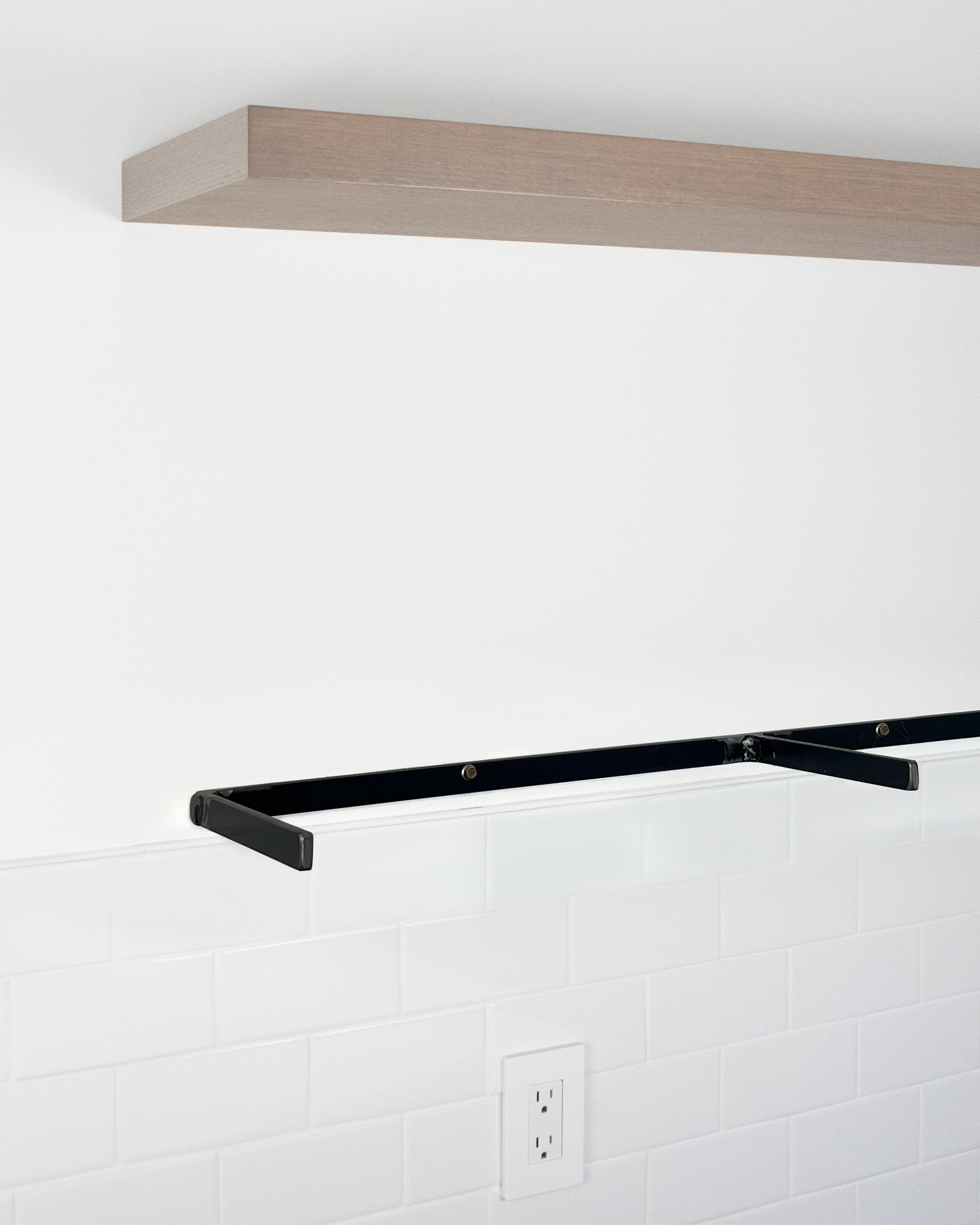 Grey oak floating wall shelf showing exposed metal bracket