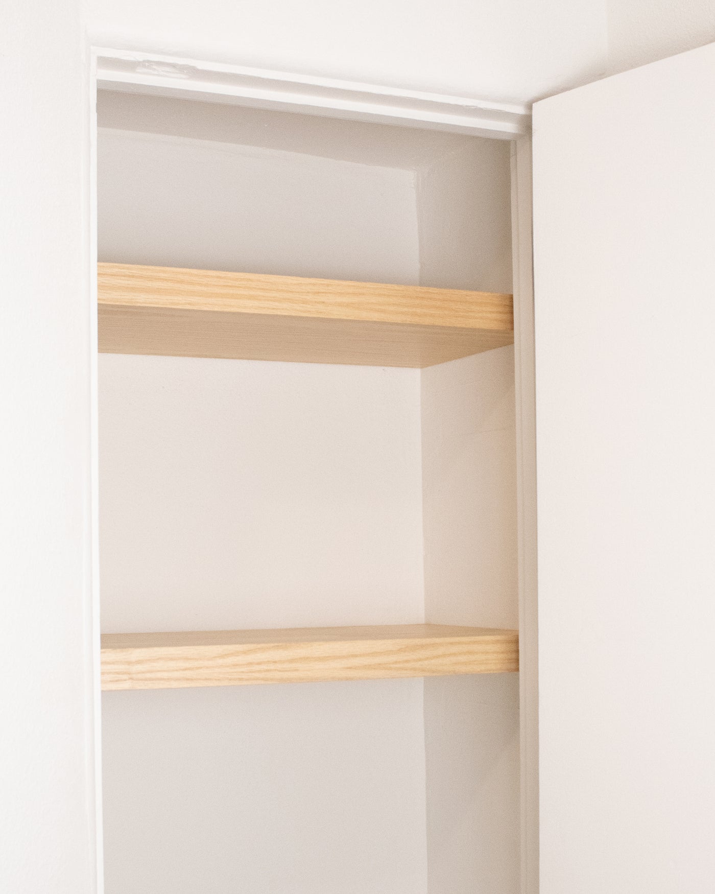 closet floating shelf split-assembly behind closet wing walls