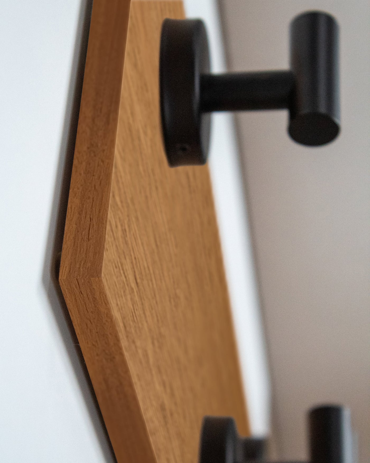 edge detail close up of African Mahogany Wood wall hook rack matte black hooks