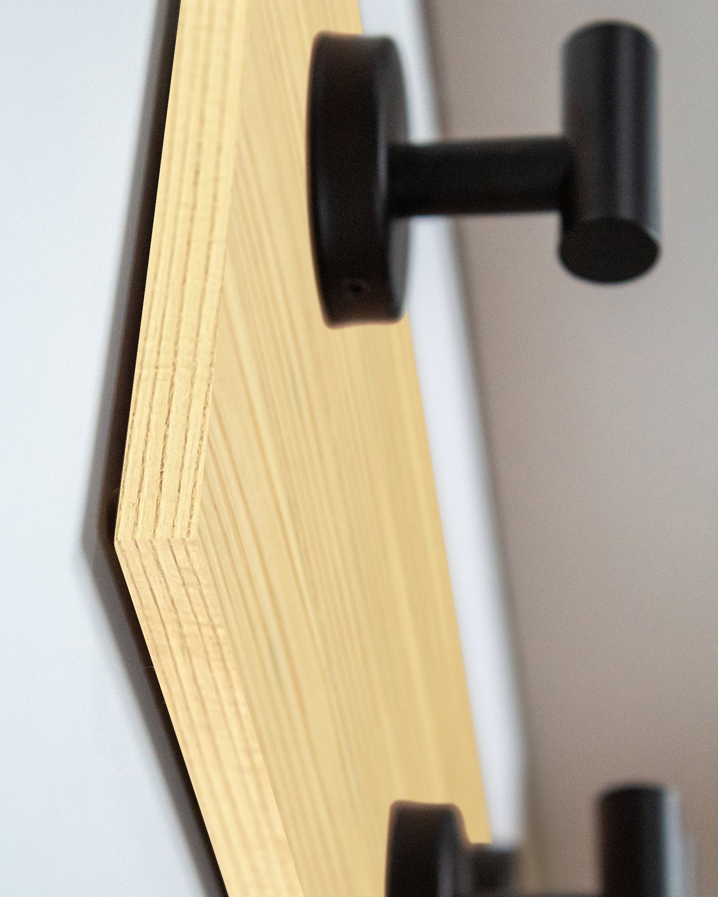 edge detail close up of Ash Wood wall hook rack matte black hooks