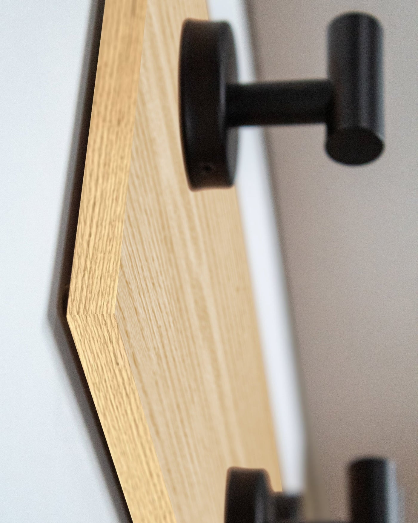 edge detail close up of bleached oak Wood wall hook rack matte black hooks