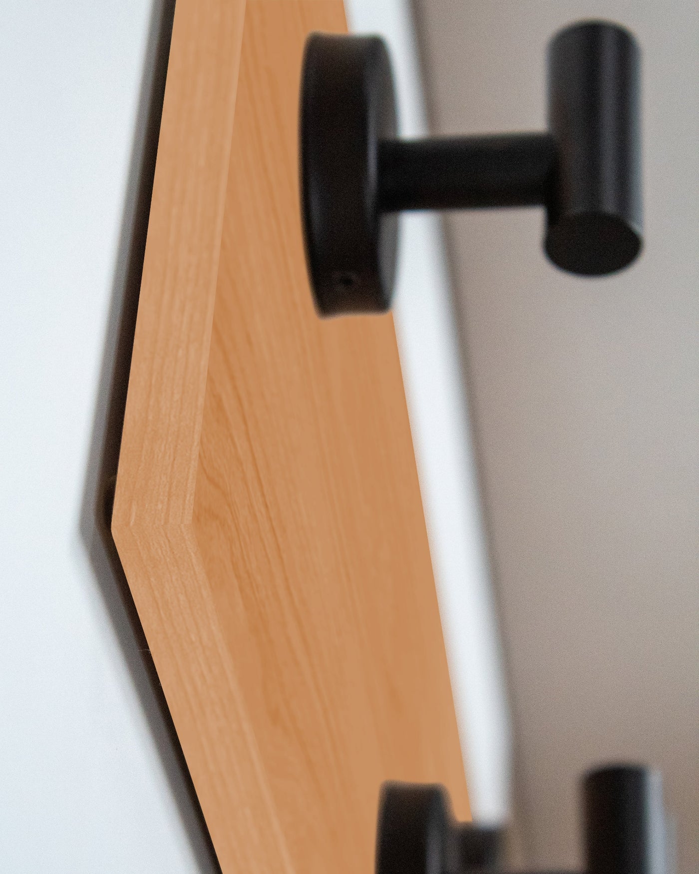edge detail close up of cherry Wood wall hook rack matte black hooks