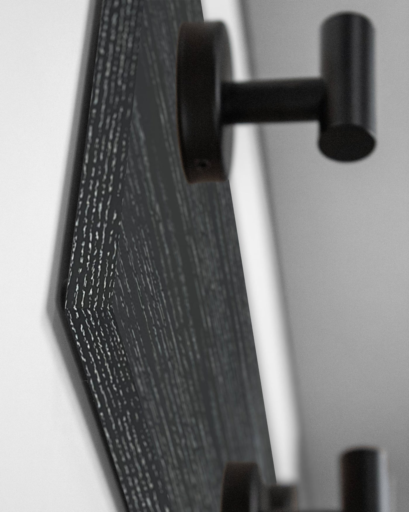edge detail close up of ebonized cerused oak wall hook rack matte black hooks