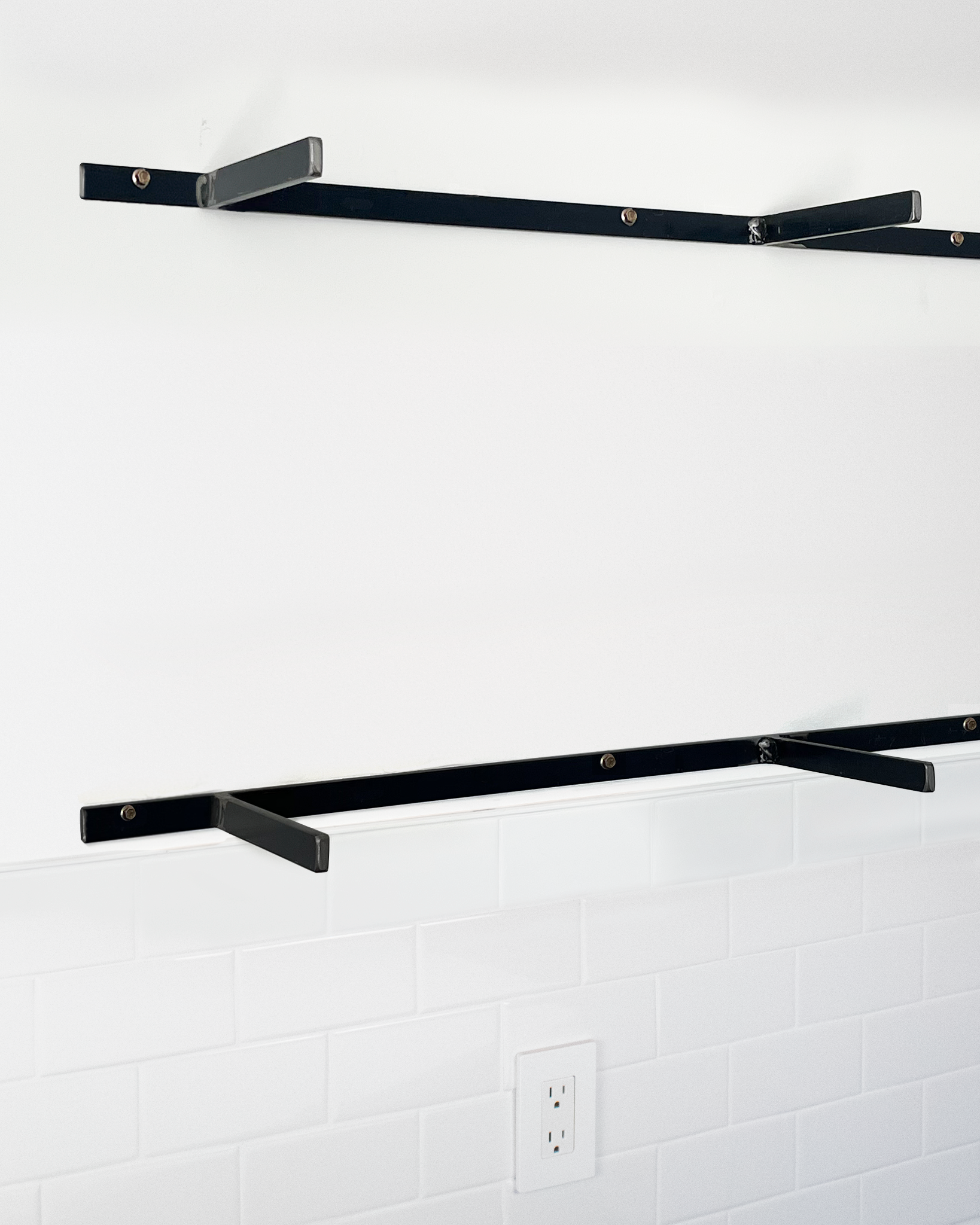 steel 1 inch floating shelf brackets installed without shelves angle view